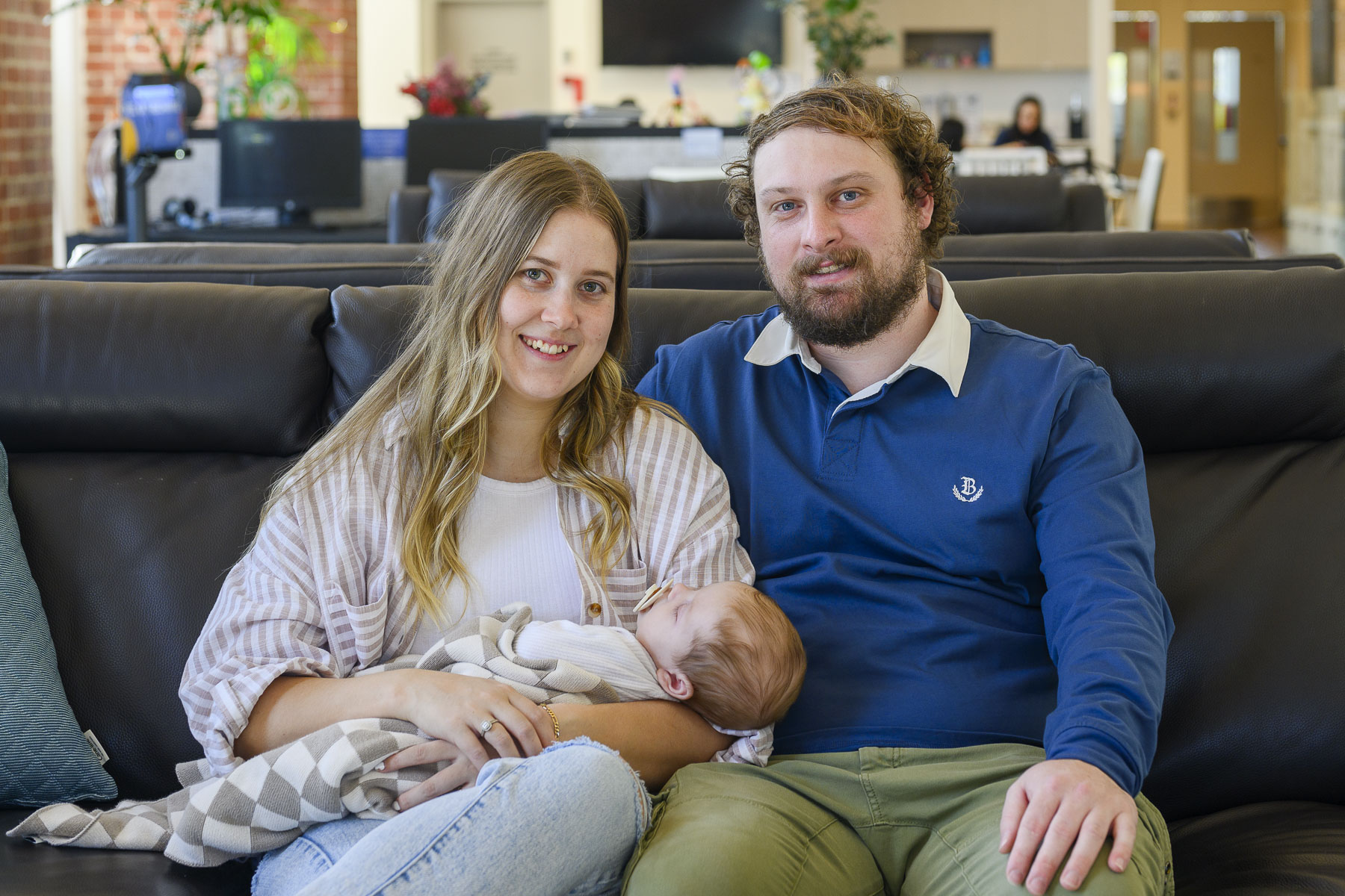 couple with baby to camera